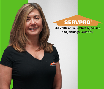 smiling woman looking at camera with a servpro logo on her right 